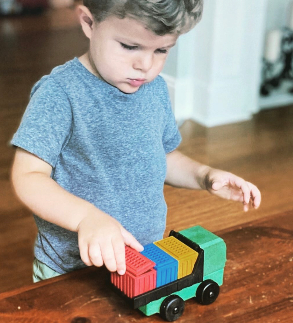 Child playing with Luke's Toy Factory Cargo Truck toy