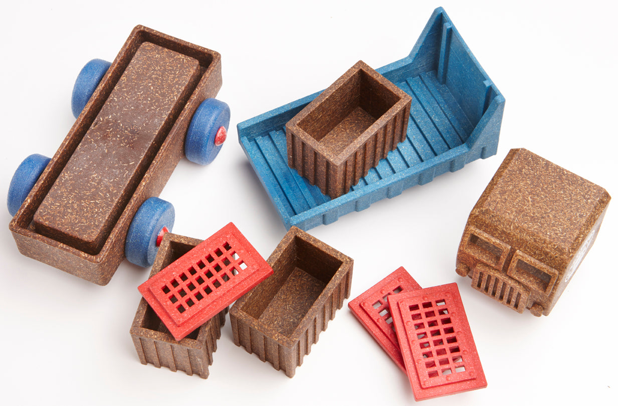 Set of toy truck parts with red cargo container and blue base. Preschool toys