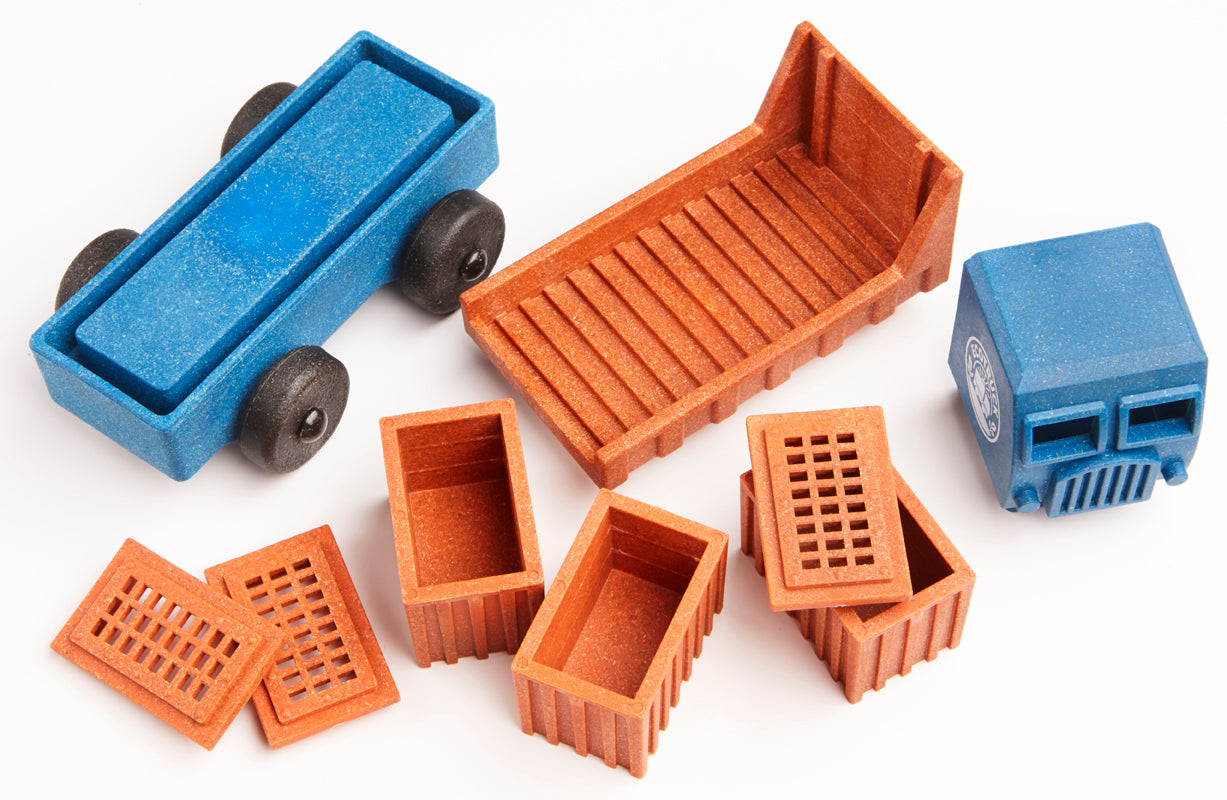 Set of educational toy truck pieces on a white background