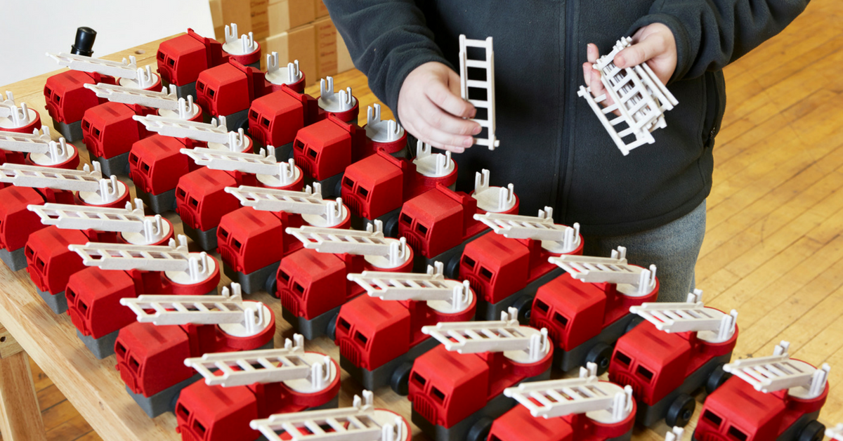 Rows of toy firetrucks in a toy factory