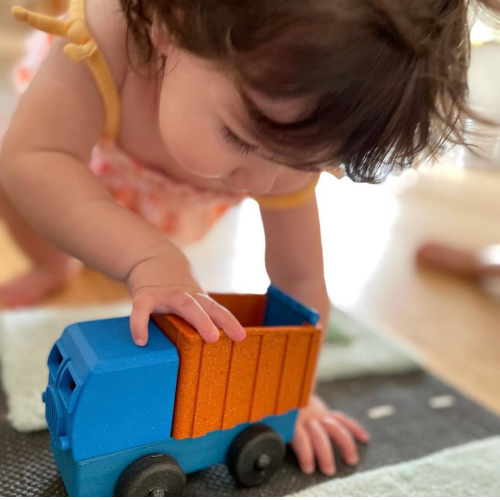 Preschool Child playing with Toy Dump Truck