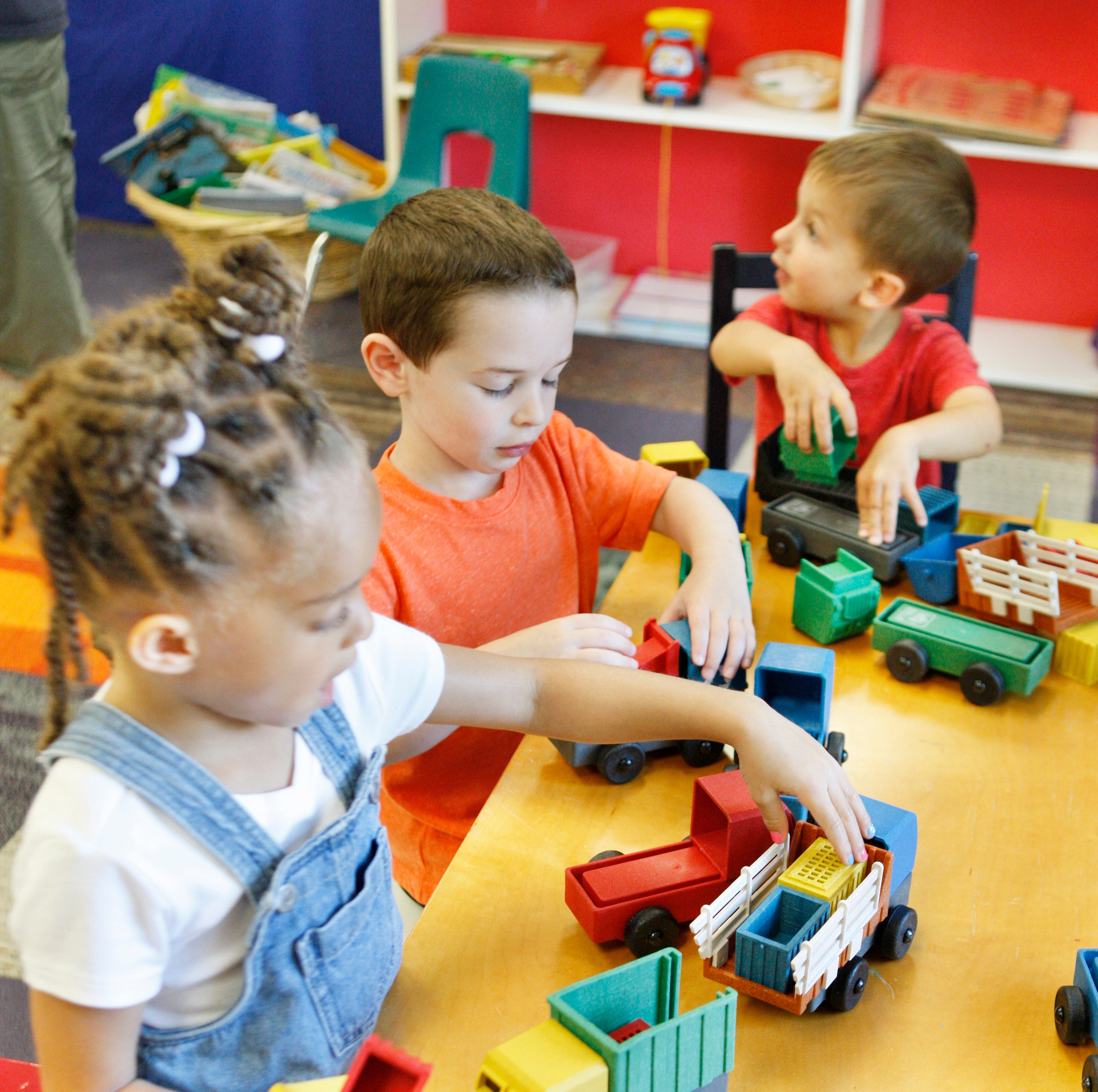 Preschooler play with educational toy trucks from Luke's Toy Factory